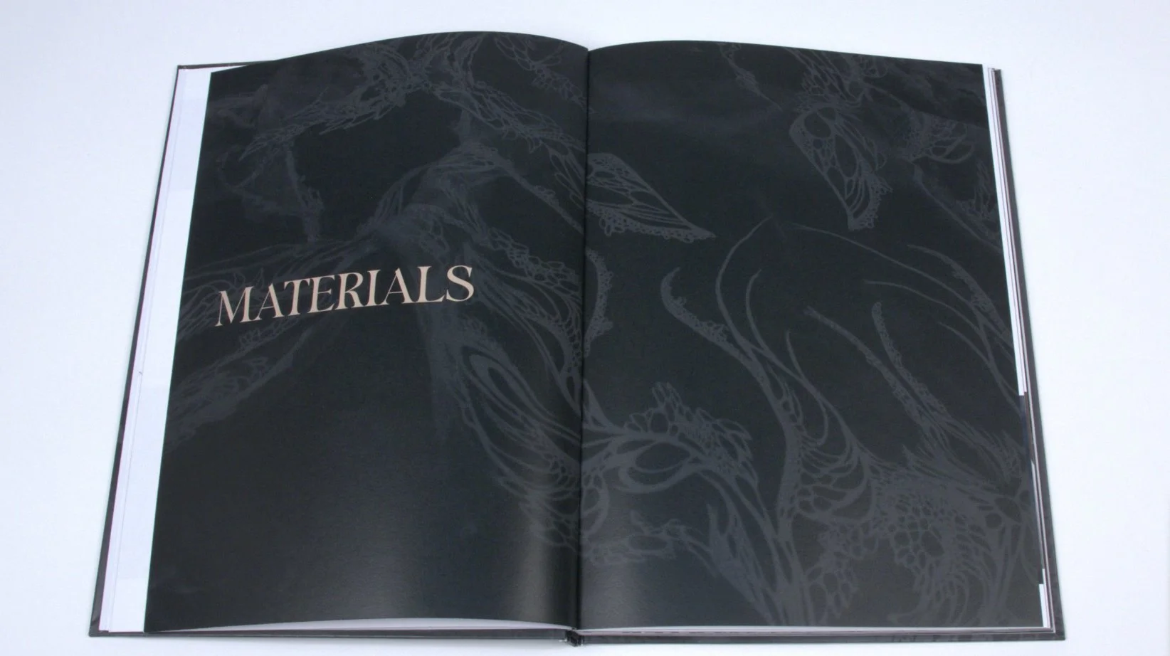 Materials chapter divider: full spread photographed at desk distance