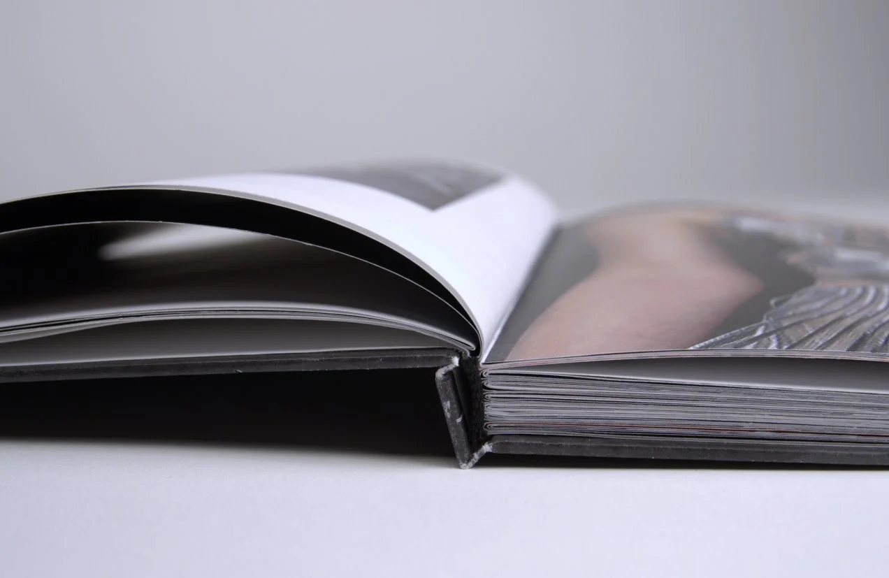 Hardcover spine close-up showing thickness, binding, and page edges