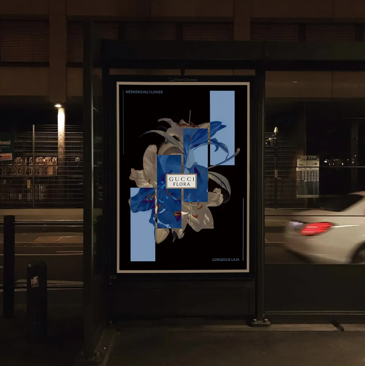 Gucci Flora poster mounted on a city bus stop at night, car passing in the background.